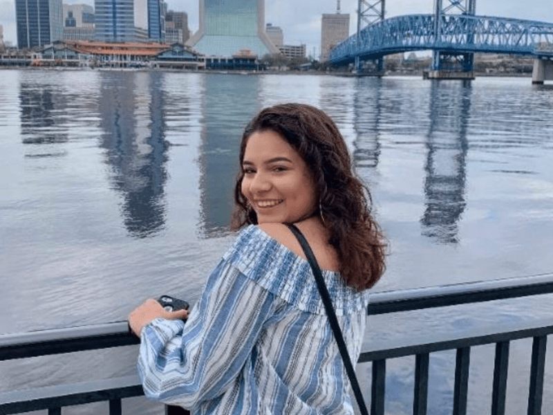 girl standing in front of St. Johns River